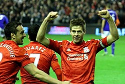 Steven Gerrard celebrating by connecting with fans. Players often point, salute or wave to their own fans, while some provoke opposition fans.