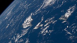 Partly cloudy conditions and a gentle breeze at 1:43 PM HDT;[69] north is oriented towards the lower right in this photo taken from the International Space Station on June 24, 2022