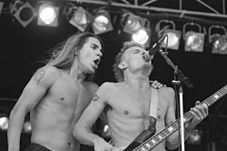 Vocalist Anthony Kiedis and bassist Flea (pictured performing at Uitmarkt in Amsterdam in August 1989) have remained with the Red Hot Chili Peppers through the band's history.