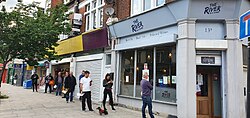 People queuing to buy beer in London on 1 May 2020, during the COVID-19 pandemic