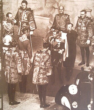King Edward VIII surrounded by heralds of the College of Arms prior to his only State Opening of Parliament on 3 November 1936