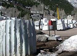 As of 2005: Background – inventory blocks of Yule Marble on the grounds of the former mill site. Foreground – fluted column section carved in the mill site prior to 1942.