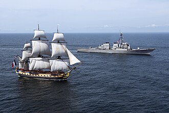 USS Mitscher, a modern guided-missile destroyer, escorting a reproduction of the 18th-century French frigate Hermione.