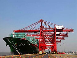 The cargo of a container ship from East Asia being unloaded at the Jawaharlal Nehru Port in Navi Mumbai, India. Increasing economic integration of Asian countries has also brought them closer politically.