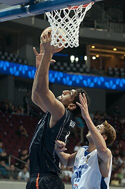 Singh (left side) with the Indian national team in 2013 scoring a right-sided layup.