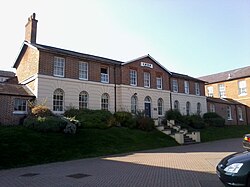 The former Andover workhouse is now a Grade II listed building and has been converted into luxury residential properties renamed "The Cloisters."