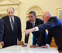 Church president Thomas S. Monson (left) and apostle Dallin H. Oaks (right) presenting U.S. president Barack Obama with his genealogy at the Oval Office in July 2009