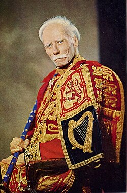 Sir Thomas Innes of Learney was Lord Lyon from 1945 to 1969, wearing the tabard of the Royal arms of the United Kingdom (with the Scottish royal arms taking precedence) and holding the staff of the Lyon's office.