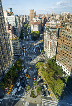 The X-shaped intersection of Broadway (from lower right to upper left) and Amsterdam Avenue (lower left to upper right), looking north from Sherman Square to West 72nd Street, and the treetops of Verdi Square