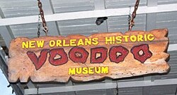 A sign for the New Orleans Historic Voodoo Museum, an attraction catering to tourist interest in Voodoo