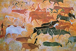 Saharan rock art from the Pastoral Period at Tassili n'Ajjer in the central Sahara, showing numerous pastoral scenes with cattle and herders