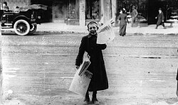 A newsboy selling the Toronto Telegram in Canada in 1905