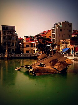 B-52 wreckage in Huu Tiep Lake, Hanoi. Downed during Operation Linebacker II, its remains have been turned into a war monument.