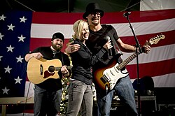 Kid Rock performing for the USO with Kellie Pickler and Zac Brown in 2008