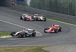 Kimi Räikkönen leading Michael Schumacher, with Jarno Trulli (Toyota) and Takuma Sato (BAR-Honda) fighting for positions at the 2005 Canadian Grand Prix