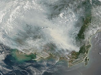 NASA's Terra satellite picture of thick smoke hung over the island of Borneo on 5 October 2006. The fires occur annually in the dry season (August–October), caused mainly by land-clearing and other agricultural fires, but fires escape control and burn into forests and peat-swamp areas.
