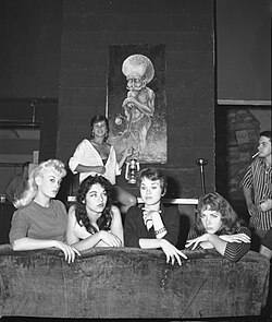 Beatniks posing in front of a piece of beatnik art, 1959. The Beat Generation are seen as a predecessor to the hippie movement