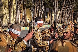 Assembling and disassembling gun parts by Iranian soldiers with closed eyes.