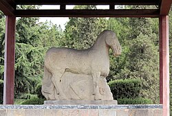 Statue of a horse trampling a Xiongnu warrior, at the mausoleum of Western Han general Huo Qubing (d. 117 BC), who fought in the Han–Xiongnu War. This is the first known monumental stone statue in China.[36]