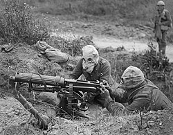 British Vickers machine gun in action near Ovillers during the Battle of the Somme in 1916. The crew is wearing gas masks.