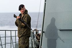 An armed Russian marine aboard a warship in the Mediterranean Sea