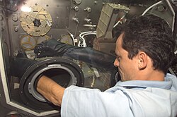 Duque working on a glovebox while aboard the International Space Station during Expedition 8