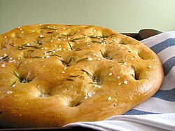 Focaccia with rosemary. Focaccia is widely associated with Ligurian cuisine.