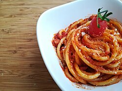 Bucatini with amatriciana sauce, which includes the New World vegetable tomato