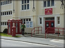 Stanley post office, with British red post and telephone boxes.
