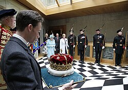 The Crown of Scotland is carried by the Duke of Hamilton as Queen Elizabeth II leaves the Chamber, following the Opening of the fourth Session in July 2011.