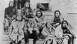 Cheyenne prisoners in Kansas involved in escape northward. From left to right: Tangle Hair, Wild Hog, Strong Left Hand, George Reynolds (interpreter), Old Crow, Noisy Walker, Porcupine, and Blacksmith. All prisoners were released free from charges.