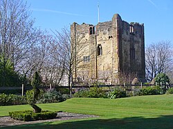 roofless stone castle keep in parkland