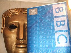 BAFTA (British Academy of Film and Television Arts) mask and the BBC logo. The BBC broadcasts BAFTA's film and television award ceremonies.