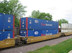An articulated double-stack well car owned by the TTX Company. The 53 ft (16.15 m) capacity car is a Gunderson Maxi-IV.