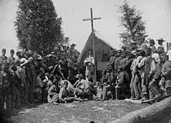 Officers and men of the Irish-Catholic 69th New York Volunteer Regiment attend church services at Fort Corcoran in 1861.