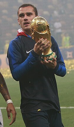 Griezmann holding the FIFA World Cup Trophy in 2018