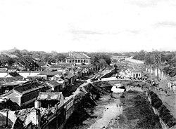 Looking north, the British Legation is the large building on the left side of the Imperial Canal. About 1900. Many Chinese people lived in the Legation Quarter in addition to the foreign diplomats and businessmen.