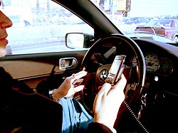 A driver using two handheld mobile phones at once