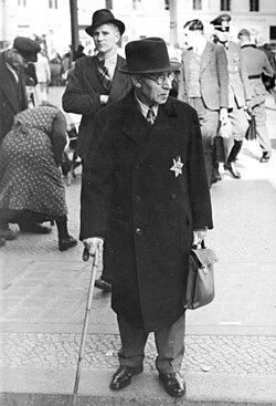 Beginning in 1941, Jews were required by law to self-identify by wearing a yellow badge on their clothing.[64]