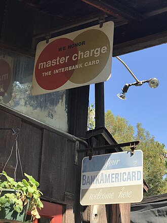 Metal signs at a plant nursery in Los Angeles County, California, marketing Master Charge and BankAmericard