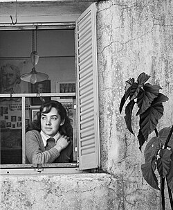 María Elena Walsh in the window of her birthplace, photographed by Grete Stern, 1947.
