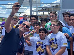 Don Garber taking a selfie with fans at the MLS All-Star Game in 2019