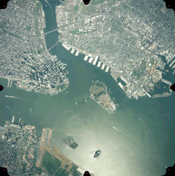 Ellis and Liberty Islands (bottom center) in Upper New York Bay at the mouth of the Hudson River (left) near Liberty State Park, seen in 1999