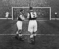 Arsenal FC wearing numbered shirts in a friendly v FC Vienna in 1933. Numbered shirts had first appeared in England in 1928 when Arsenal played Sheffield Wednesday. Their use would not be ruled mandatory until 1939