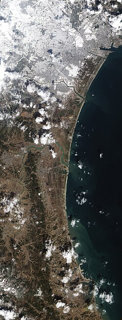 Satellite image shows snowfall on agricultural fields in Sendai area. See § Weather conditions paragraph for details.