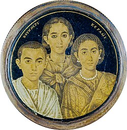 A gold glass portrait of a family from Roman Egypt. The Greek inscription on the medallion may indicate either the name of the artist or the pater familias who is absent in the portrait.[j][166]