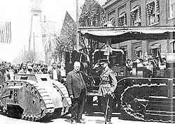 Swinton and Benjamin Holt in Stockton, California, on 22 April 1918, with a Holt caterpillar tractor (right) and a model of a British tank (left).