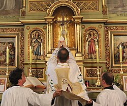 The elevation of the host began in the 14th century to show people the consecrated host.