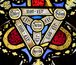 The Holy Trinity on the stained glass windows of the Church of Saint Peter and Saint Paul in Brockdish