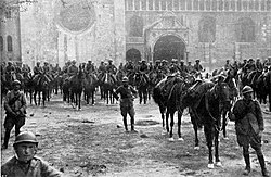Italian troops in Trento on 3 November 1918, after the Battle of Vittorio Veneto. Italy's victory marked the end of the war on the Italian Front and secured the dissolution of Austria–Hungary.[73]